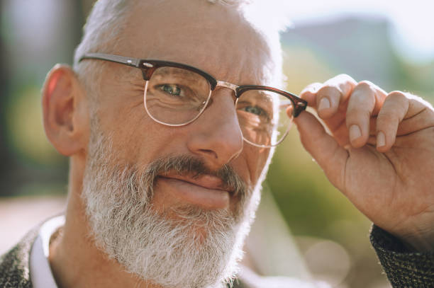 istock Mustached bearded male in round spectacles looking ahead 1360498881