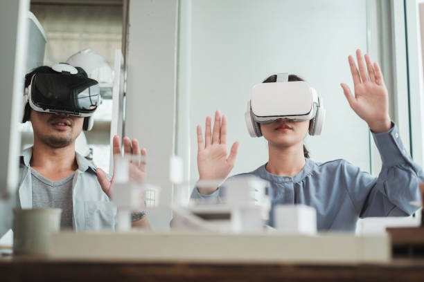 istock Architect wearing virtual reality headset for detail project house model. 1360499891