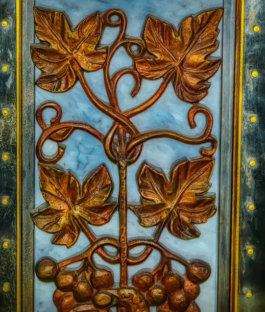 Vintage gold plated shell leg with floral decoration, frequently used in Christian religious objects.
