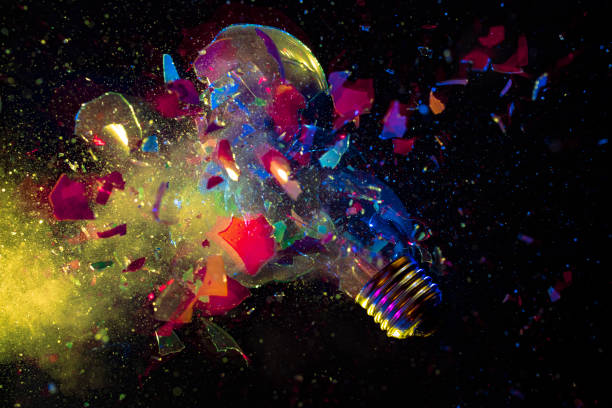 istock explosion of a colorful light bulb on black. 1360502520