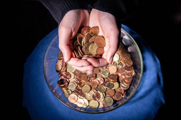istock Euro coins manipulated by woman's hands 1360504968