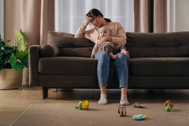 istock Young tired mother with headache suffering from postnatal depression 1360505311