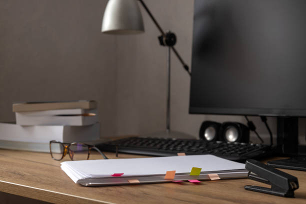 istock Office workspace.Stack of paper,documents,books,empty screen and glasses on the wooden desk.Free space for design 1360505459