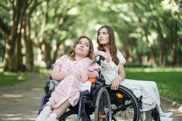 istock Pleasant women with disability posing at summer park 1360506896