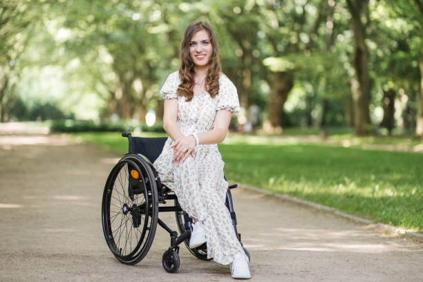 istock Woman with physical disability spending time at park 1360507784