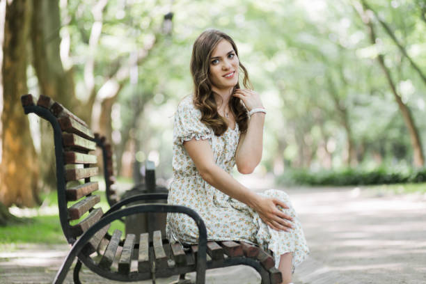 istock Smiling woman who lives with disability posing at park 1360507984