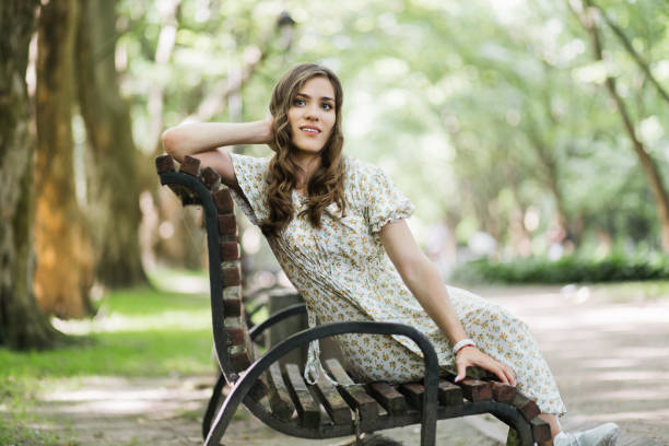 istock Woman with physical disability smiling among green park 1360508021