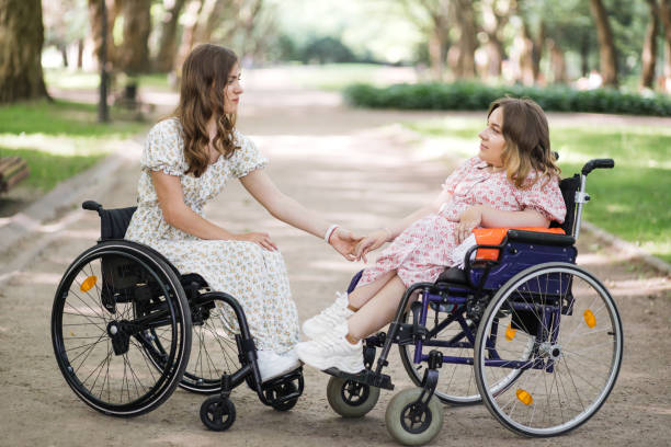 istock Ladies with disability looking on each other at green park 1360508088