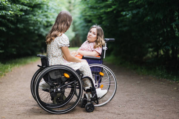 istock Two disabled women enjoying summer time at green park 1360508348