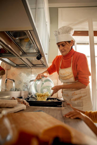 istock Grandmother preparing baked potatoes 1360509189