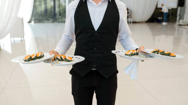 istock waiter holding plates with appetizer in the restaurant. 1360509497