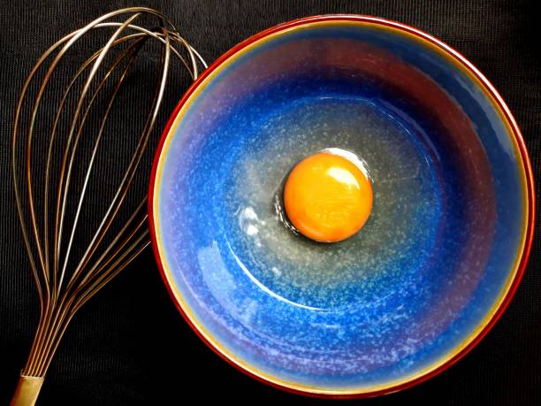 istock Chicken egg yolk and beater. 1360511695