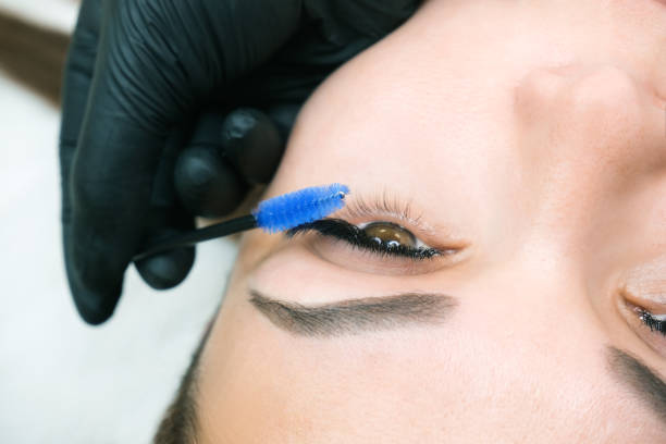 istock Eyelash extension procedure. Woman eye with long eyelashes. 1360512452