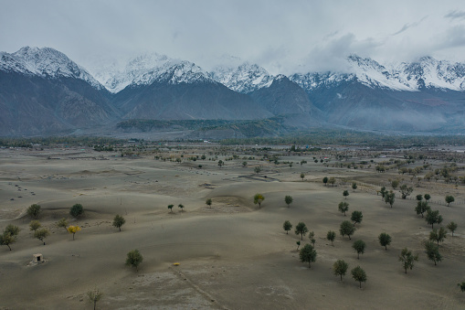 Scenic aerial view of Katpana Desert in Northern Pakistan on the background of Karakoram mountains