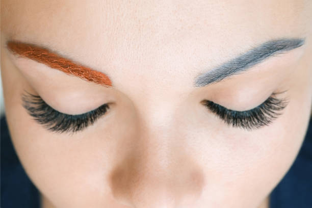 istock overlapping of unsuccessful permanent makeup on the eyebrows. Applying a warm tone to a cool blue color 1360513443