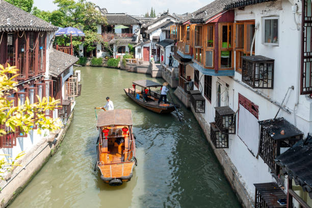 Sightseeing tour on Chinese traditional rowboat along the canal in Zhujiajiao Ancient Water Town, a historic village and famous tourist destination in the Qingpu District of Shanghai, China Shanghai, China - September 2019: Sightseeing tour on Chinese traditional rowboat along the canal in Zhujiajiao Ancient Water Town, a historic village and famous tourist destination in the Qingpu District of Shanghai, China Zhujiajiao stock pictures, royalty-free photos & images