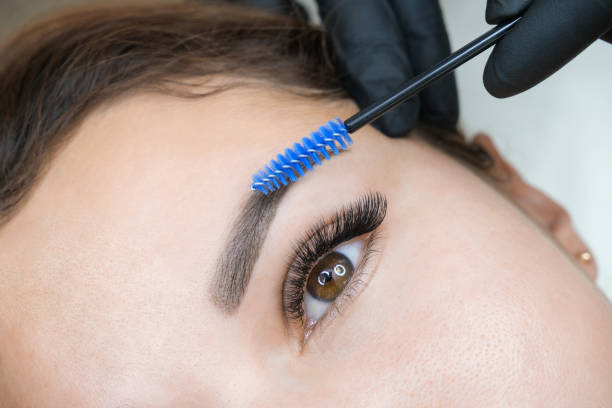 istock Young woman shaping eyebrows with brush 1360514451