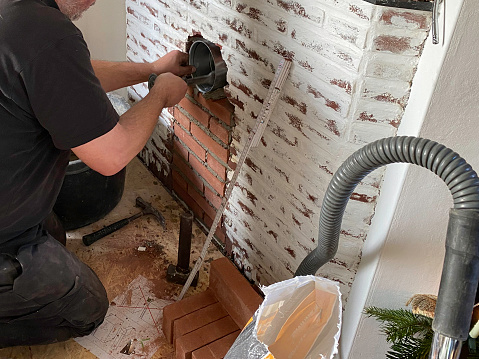 Installing a chimney connection with a sliding sleeve in a brick mantel piece  for a new  wood stove