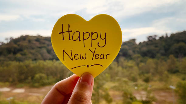 istock Happy New Year wishes text on a sticky post it note with blurred nature background 1360518046