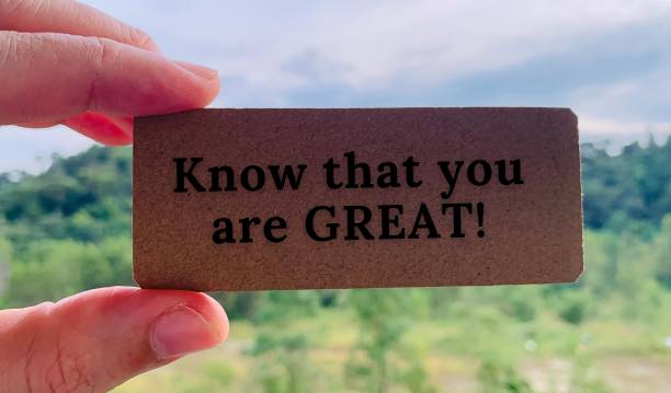 istock Image with text saying know that you are great written on a brown small cardboard with blurred nature background 1360518555