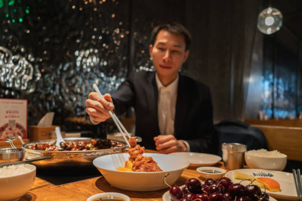 istock Asian man eating in Chinese restaurant 1360518685