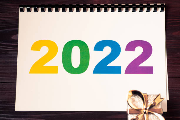 2022 multicolored numbers on a piece of paper and a gift lying. 2022 multicolored numbers on a piece of paper and a gift lying. 4789 квед 2021 stock pictures, royalty-free photos & images