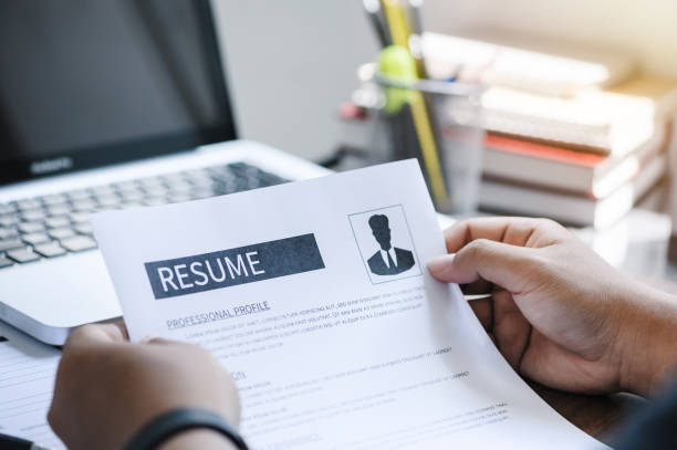istock Man writing resume and CV in-home office with laptop. before send for new work and typing curriculum vitae for application. Job seeking, hunt, and unemployment 1360521393