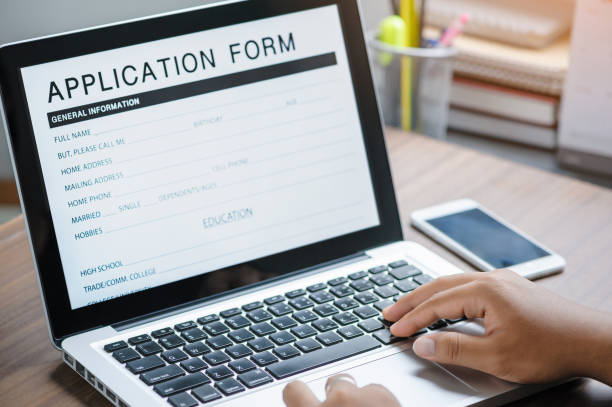 istock business man working on laptop computer and application Form Information for the searching job or fill out personal data for online web job the application form. Employment Concept. 1360521408