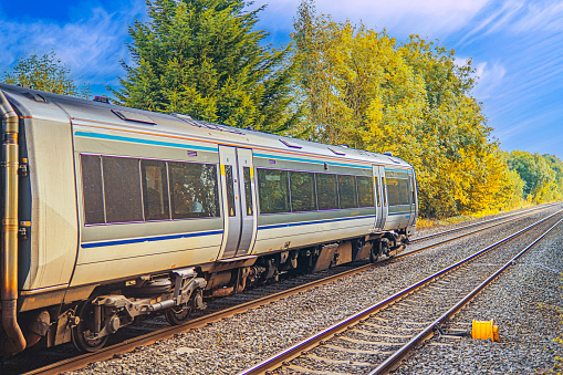 A station England UK. Diesel powered railway line in the English countryside. Station on a sunny day.