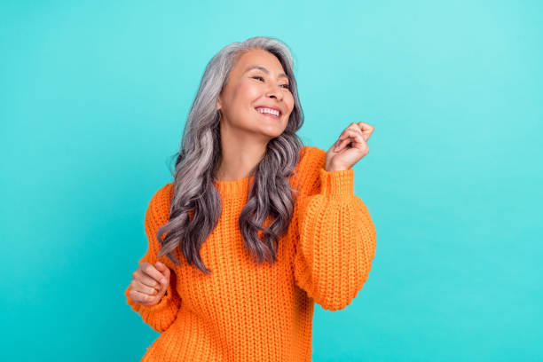 Profile side photo of mature cheerful pretty lady have fun clubber look empty space isolated over turquoise color background Profile side photo of mature cheerful pretty lady have fun clubber look empty space isolated over turquoise color background. middle aged woman fashion stock pictures, royalty-free photos & images