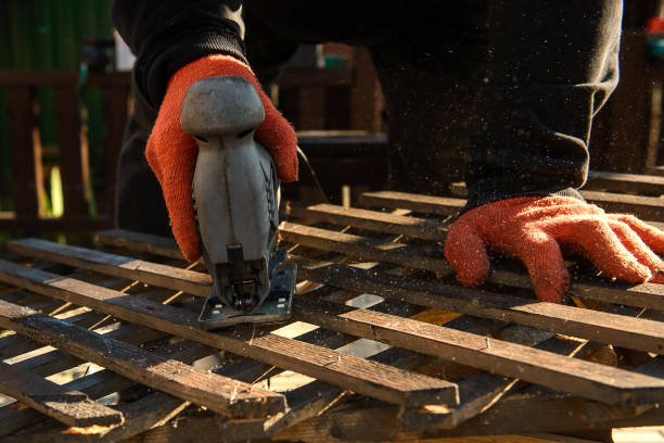 istock Cutting wood with electric jigsaw. 1360523138