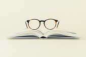 Reading glasses on open book