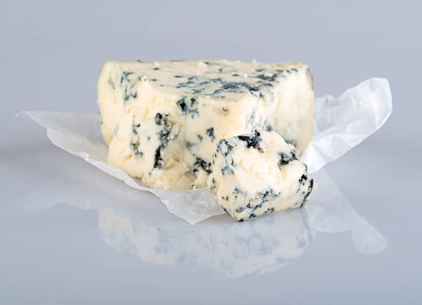 istock A piece of cheese with blue mold isolated on a white background with reflection 1360525330