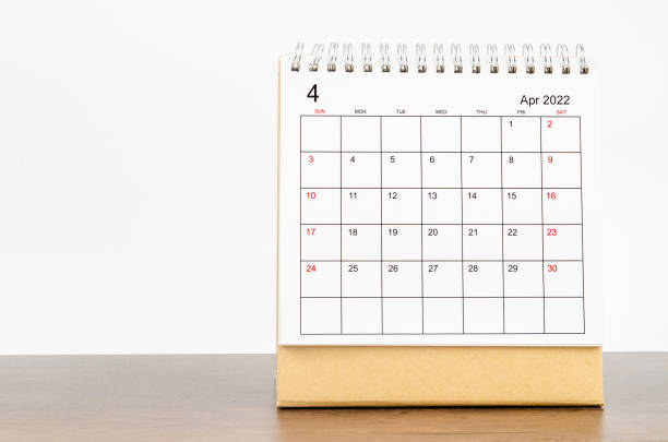 istock April 2022 desk calendar on wooden table. 1360525670
