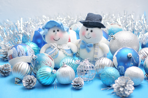Christmas Snowman and Snow Maiden surrounded by New Year's toys\