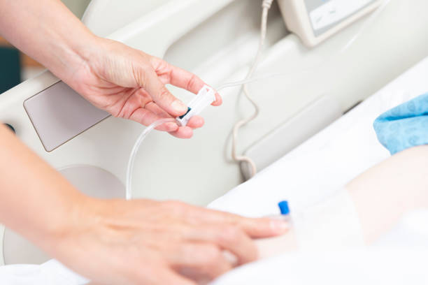 istock Female doctor opens vascular access to patient 1360527630