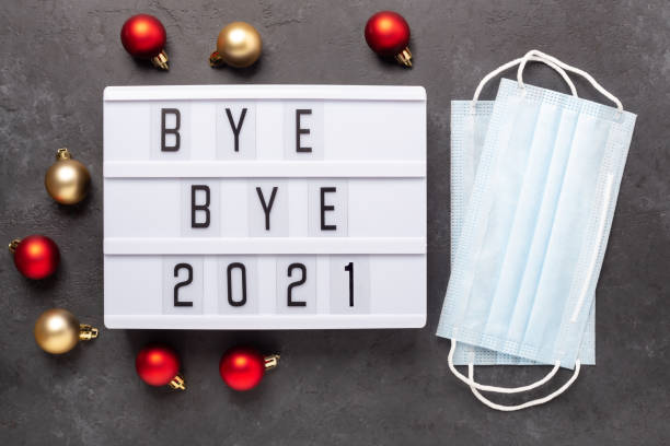 istock Lightbox with text BYE BYE 2021 with medical mask on dark background. Top view. New year celebration. Happy New Year 2022 concepts 1360527742