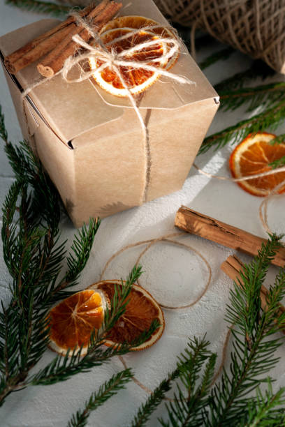 istock Christmas gift paper box decorated with dry oranges and cinnamon 1360531302