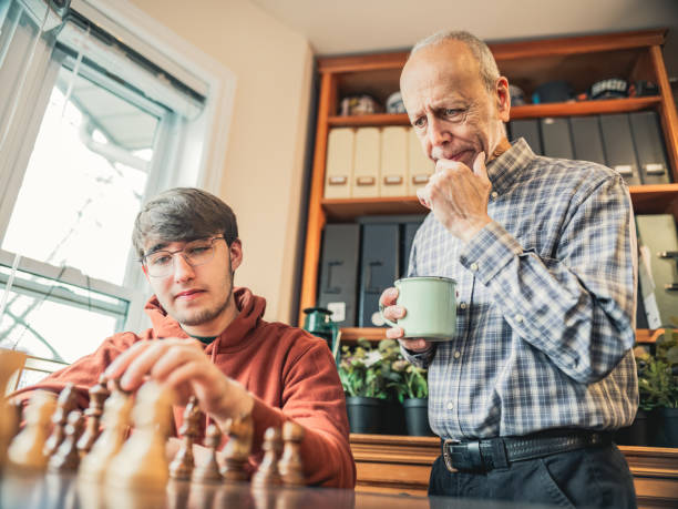 istock Grandfather and Grandson playing chess at home 1360536043