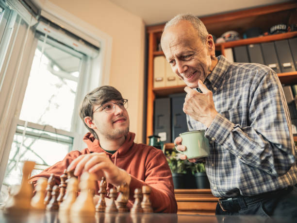 istock Grandfather and Grandson playing chess at home 1360536099