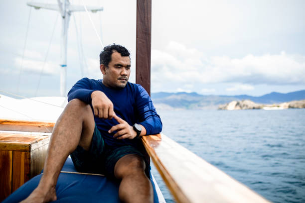istock asian man sitting on the deck during traveling by ship 1360538791