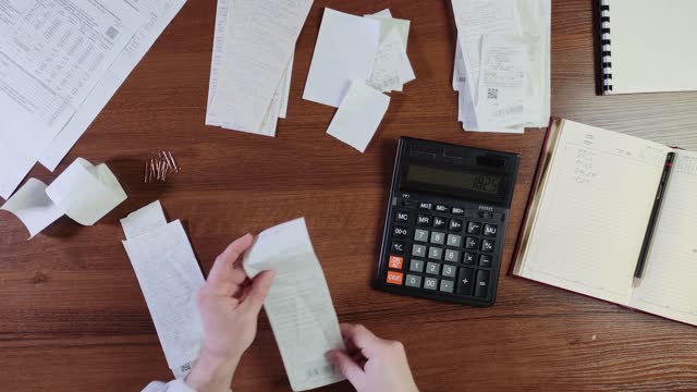 Home budget. Man reviewing receipts. Time-lapse