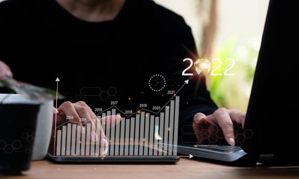 istock A lady uses a tablet computer to display a stock graph. The concept involves financial and business analytics, with plans to boost corporate growth and signs of good growth in 2022. 1360541403