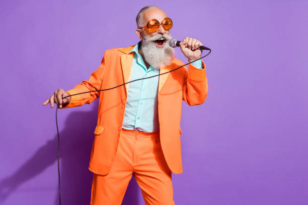 Photo of old funny funky cool man sing mic karaoke good mood enjoy isolated on purple color background stock photo