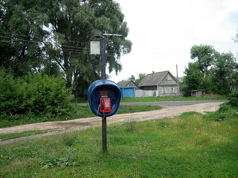 A modern payphone telephone in the middle of a village in the remote Russian hinterland