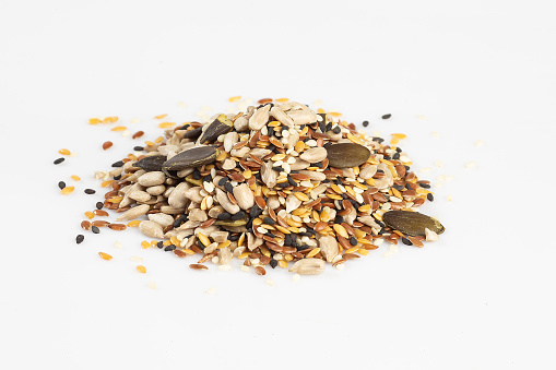 raw seeds mix isolated on white background. vegan concept.