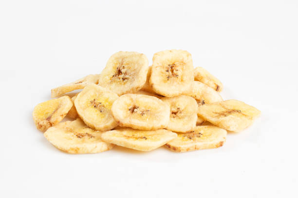 istock Dried banana chips isolated on white backgrond 1360544006