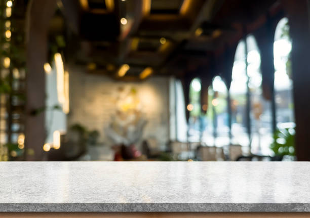 istock Empty white marble stone table top and blur interior cafe and restaurant. 1360545319