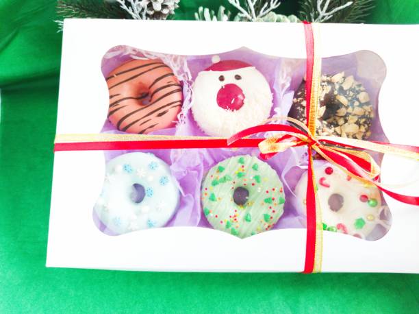 istock christmas donut box, donuts with icing and sprinkles 1360546023