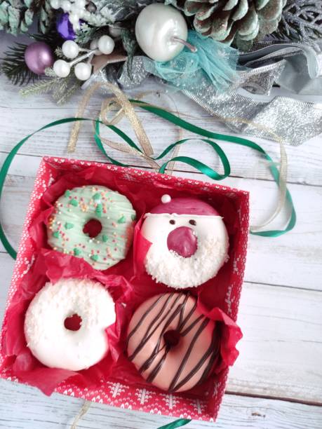 istock christmas donut box, donuts with icing and sprinkles 1360546046